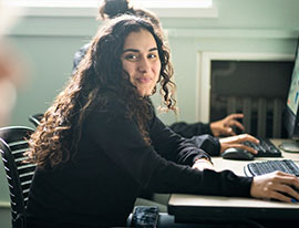 A student smiling while working on the computer. Links to Beneficiary Designations A student smiling while working on the computer. Links to Beneficiary Designations